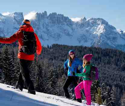 Three people snowshoe hiking